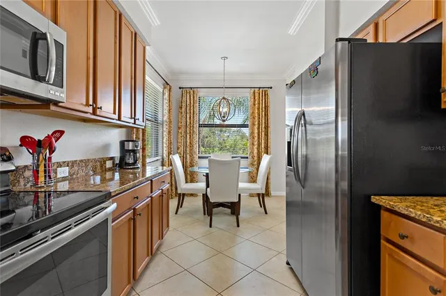 a kitchen with stainless steel appliances granite countertop a sink and cabinets