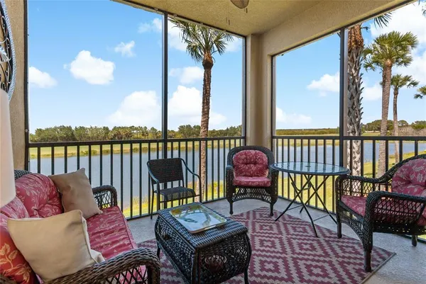 a living room with furniture a flat screen tv and a large window