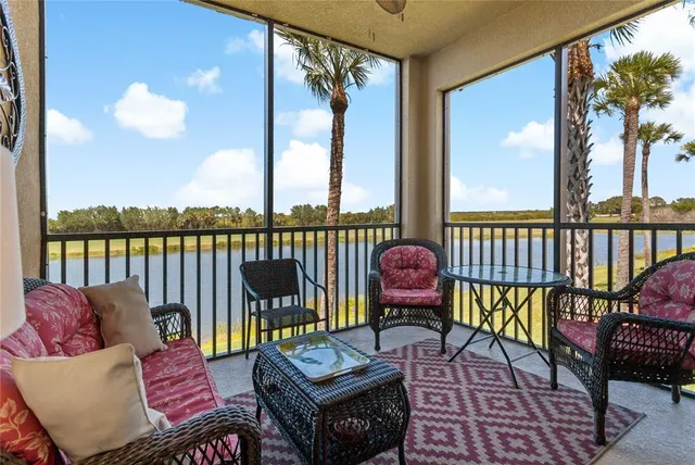 a living room with furniture a flat screen tv and a large window
