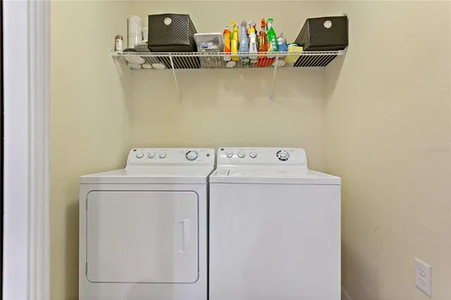 an aerial view of residential houses with outdoor space and lake view