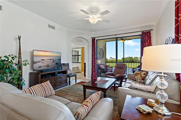 a living room with furniture ceiling fan and a rug
