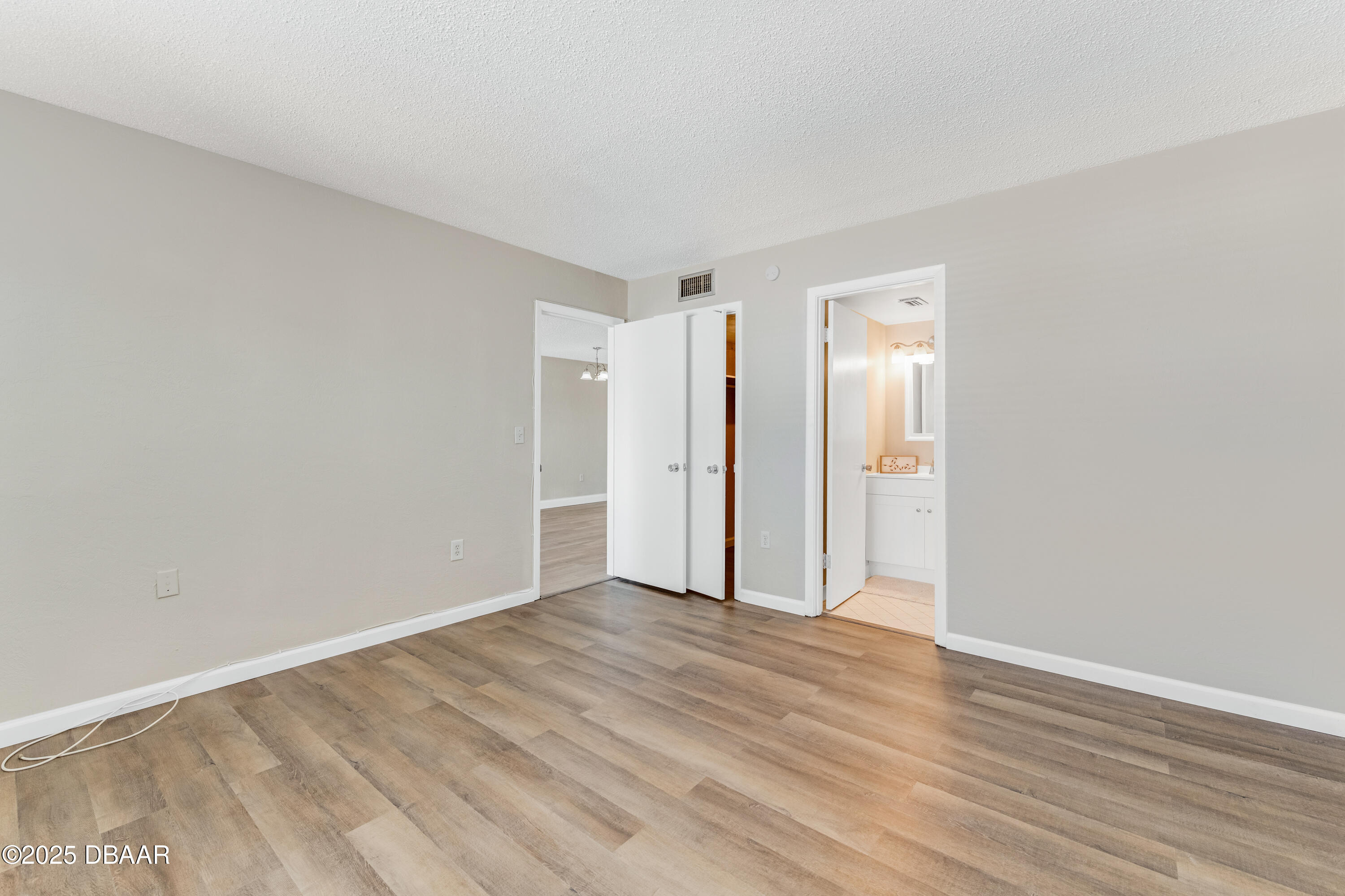2711 North Halifax Avenue, Unit 794 Daytona Beach, FL 32118 - Photo 14 of 22 a view of an empty room with wooden floor