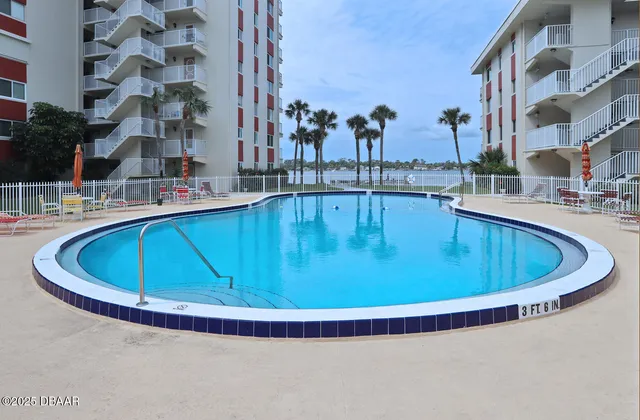 a view of swimming pool with outdoor seating