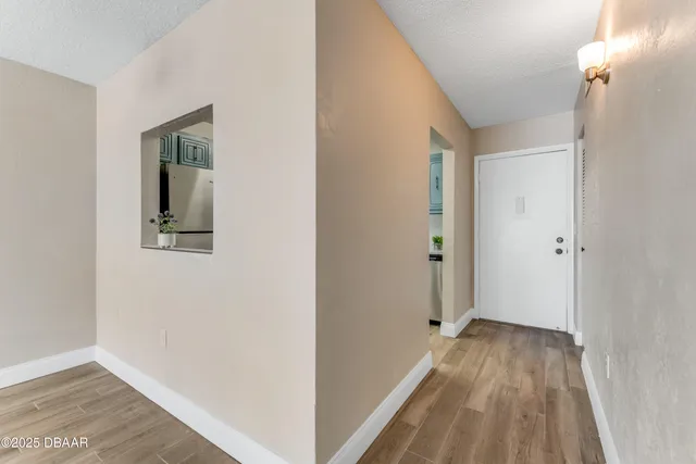 a view of a hallway with wooden floor