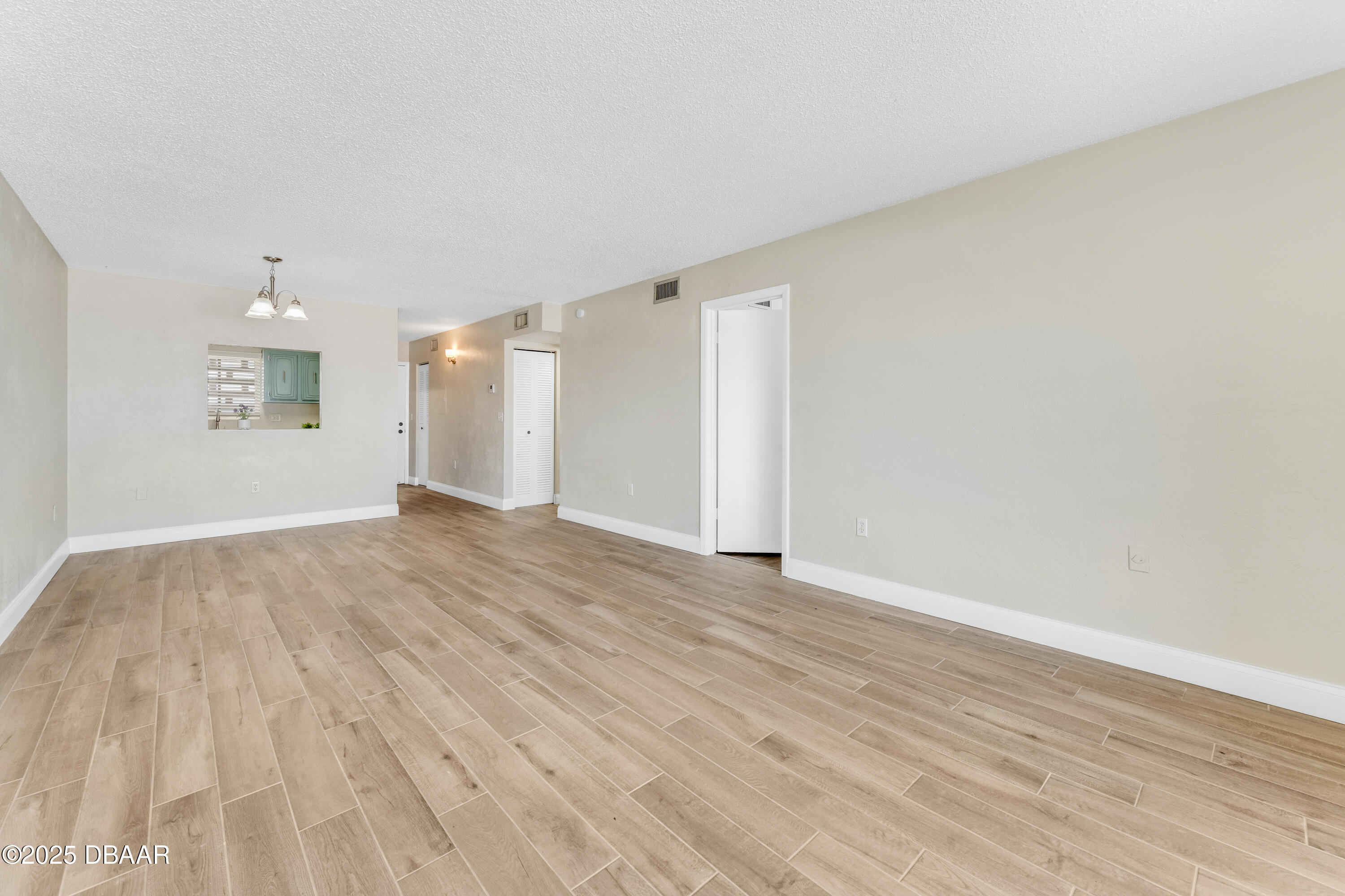 2711 North Halifax Avenue, Unit 794 Daytona Beach, FL 32118 - Photo 9 of 22 a view of an empty room and wooden floor