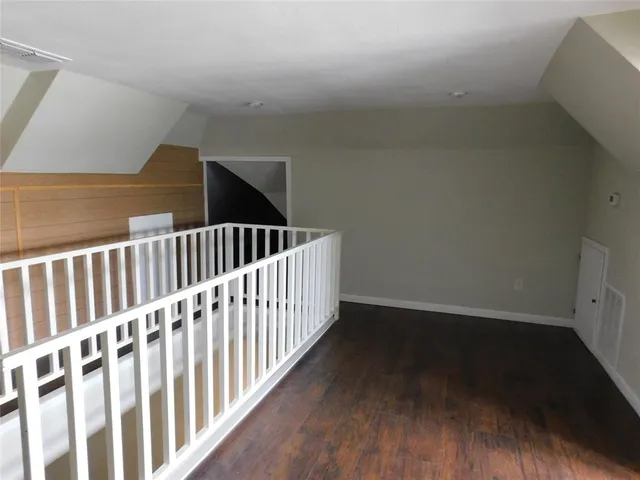 a view of hallway with wooden floor