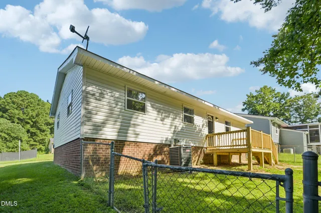 a view of house with backyard