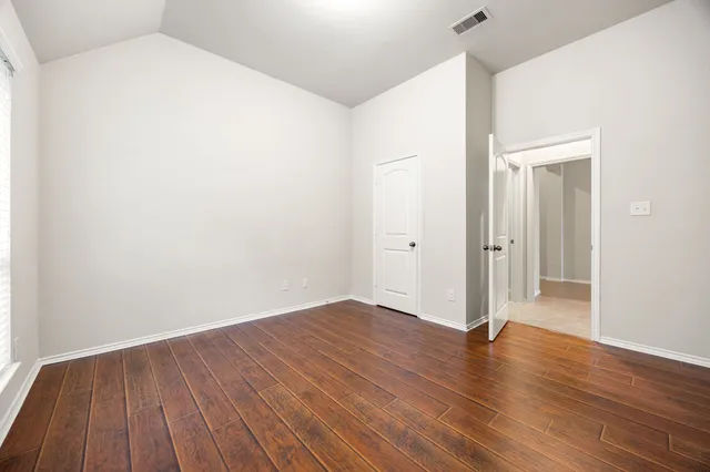 an empty room with wooden floor