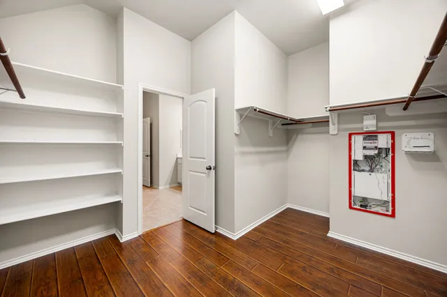 a view of walk in closet with empty racks
