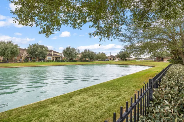 a view of a lake with houses in the back