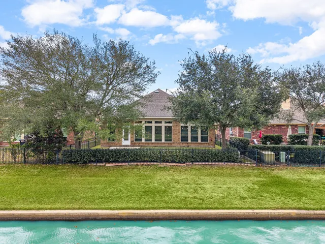 a front view of house with yard and trees