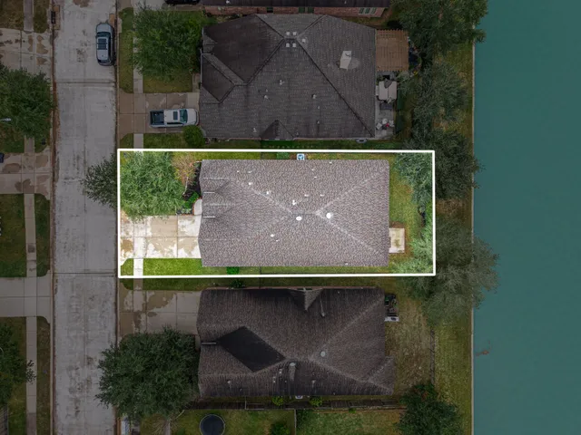 an aerial view of a house with a yard