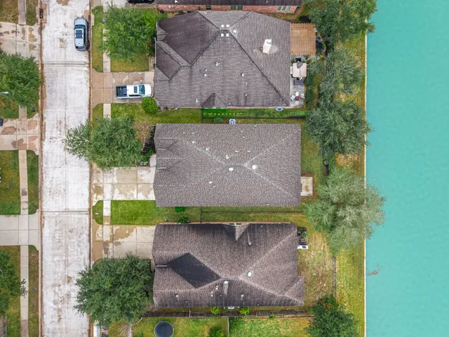 an aerial view of a house with a yard and a fountain
