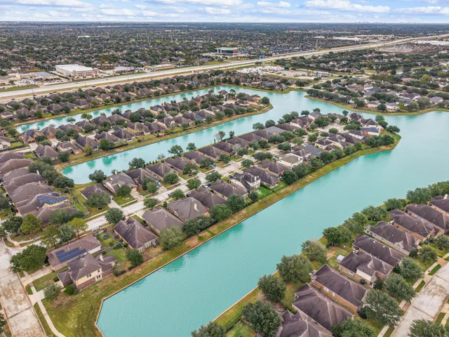 an aerial view of residential building and lake