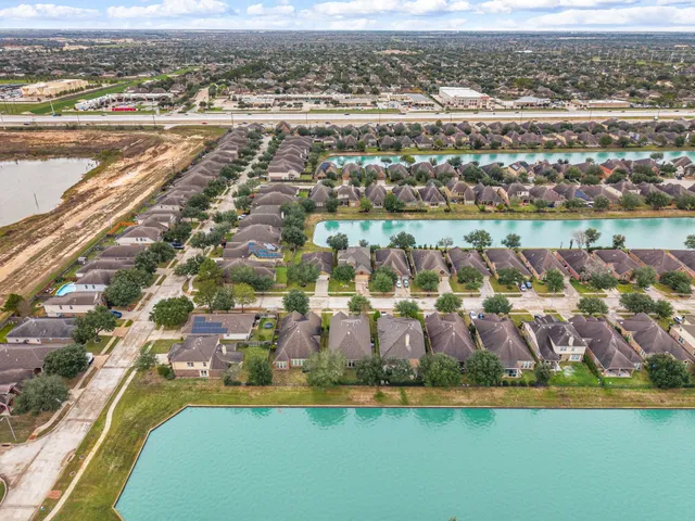 an aerial view of residential houses with outdoor space