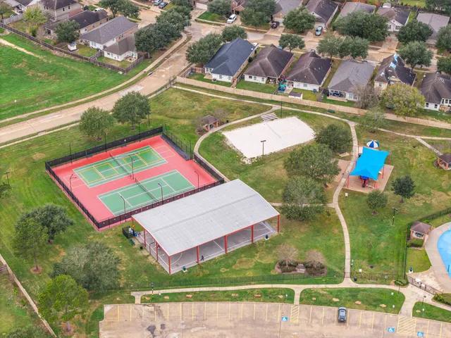 an aerial view of a pool a yard basket ball court and outdoor seating