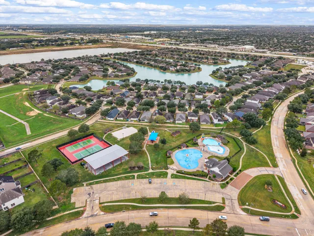 an aerial view of a swimming pool and outdoor seating