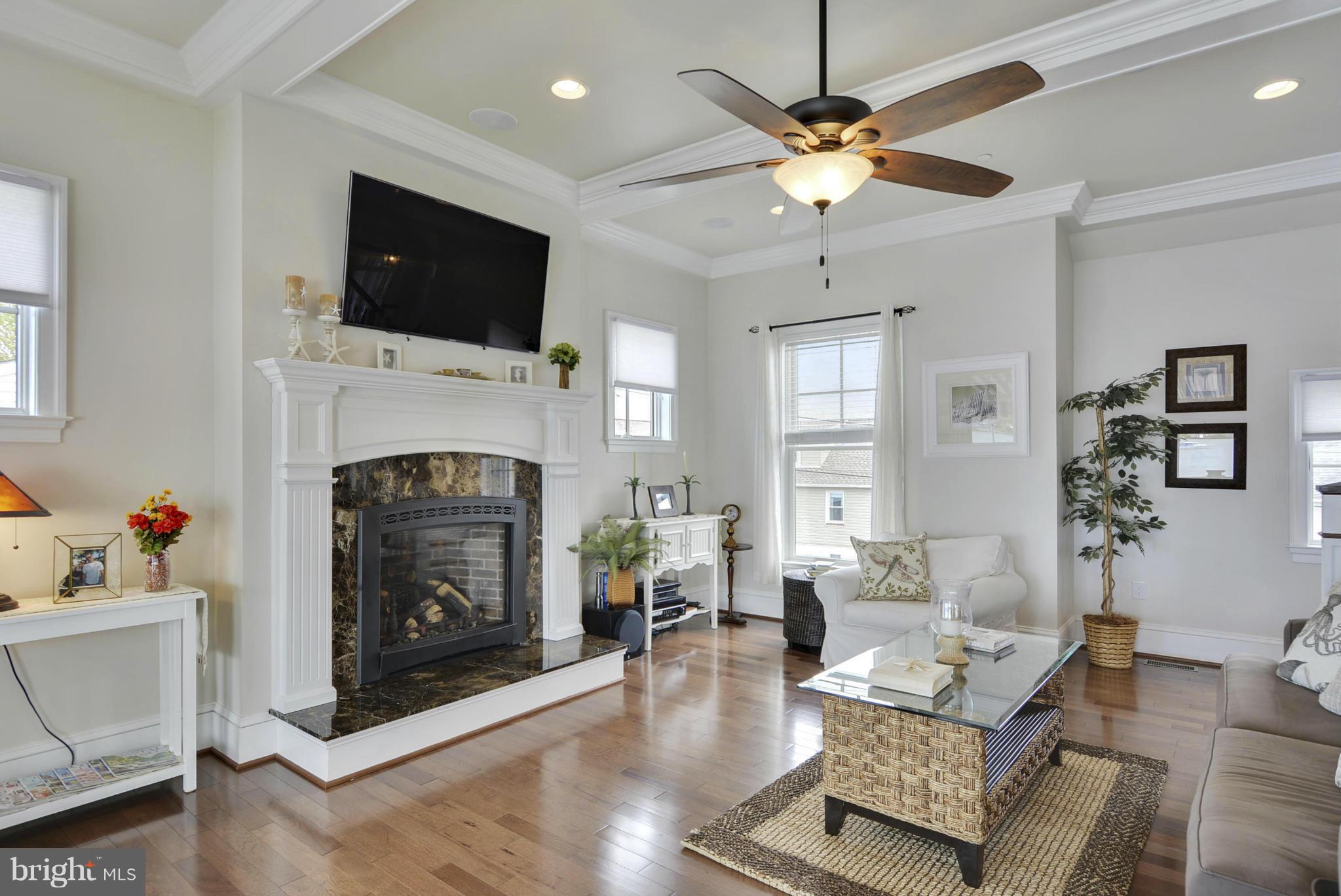 1824 Wilson Point Road Baltimore, MD 21220 - Photo 16 of 28 a living room with furniture a fireplace and a flat screen tv