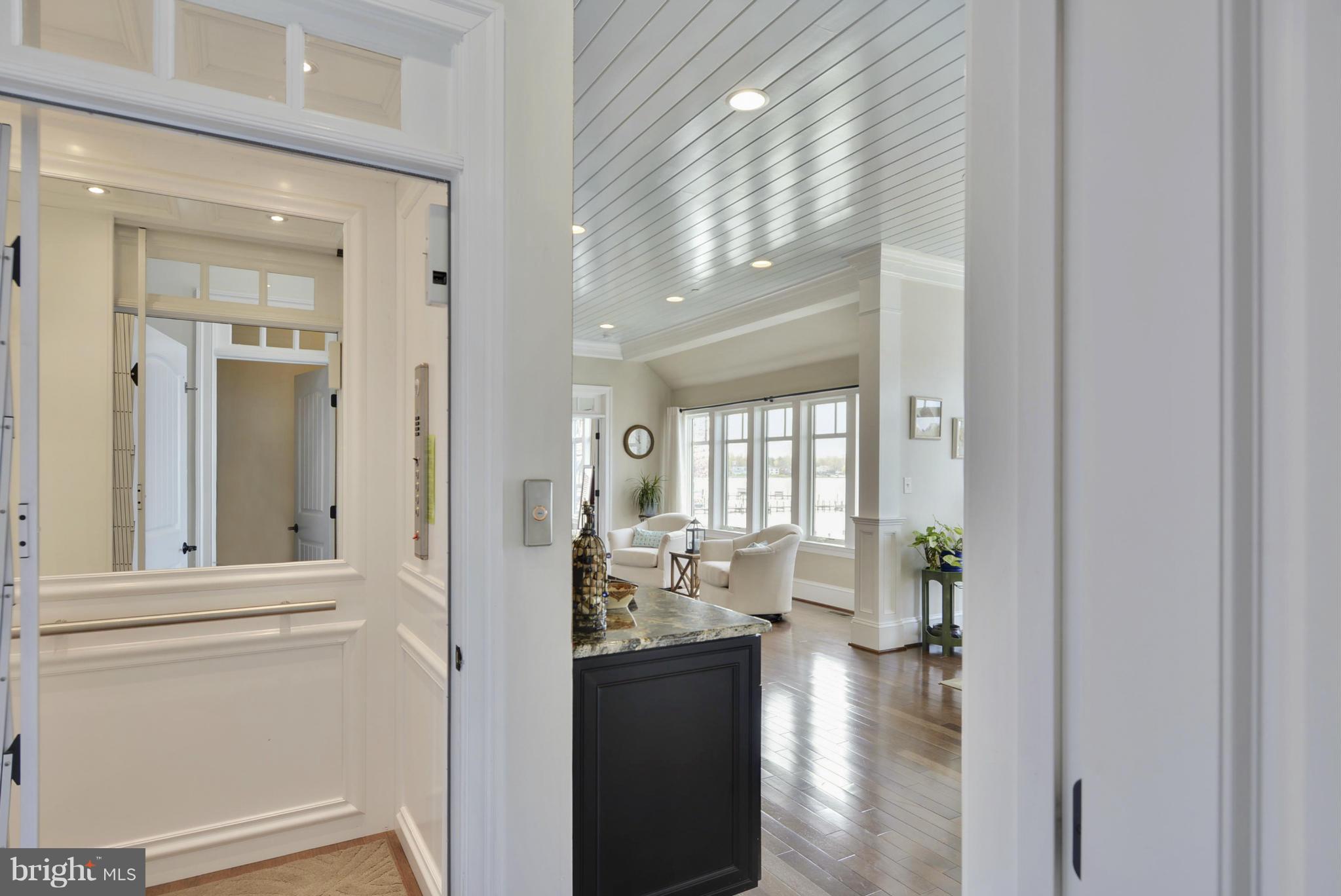 1824 Wilson Point Road Baltimore, MD 21220 - Photo 18 of 28 a view of a hallway with furniture and floor to ceiling window