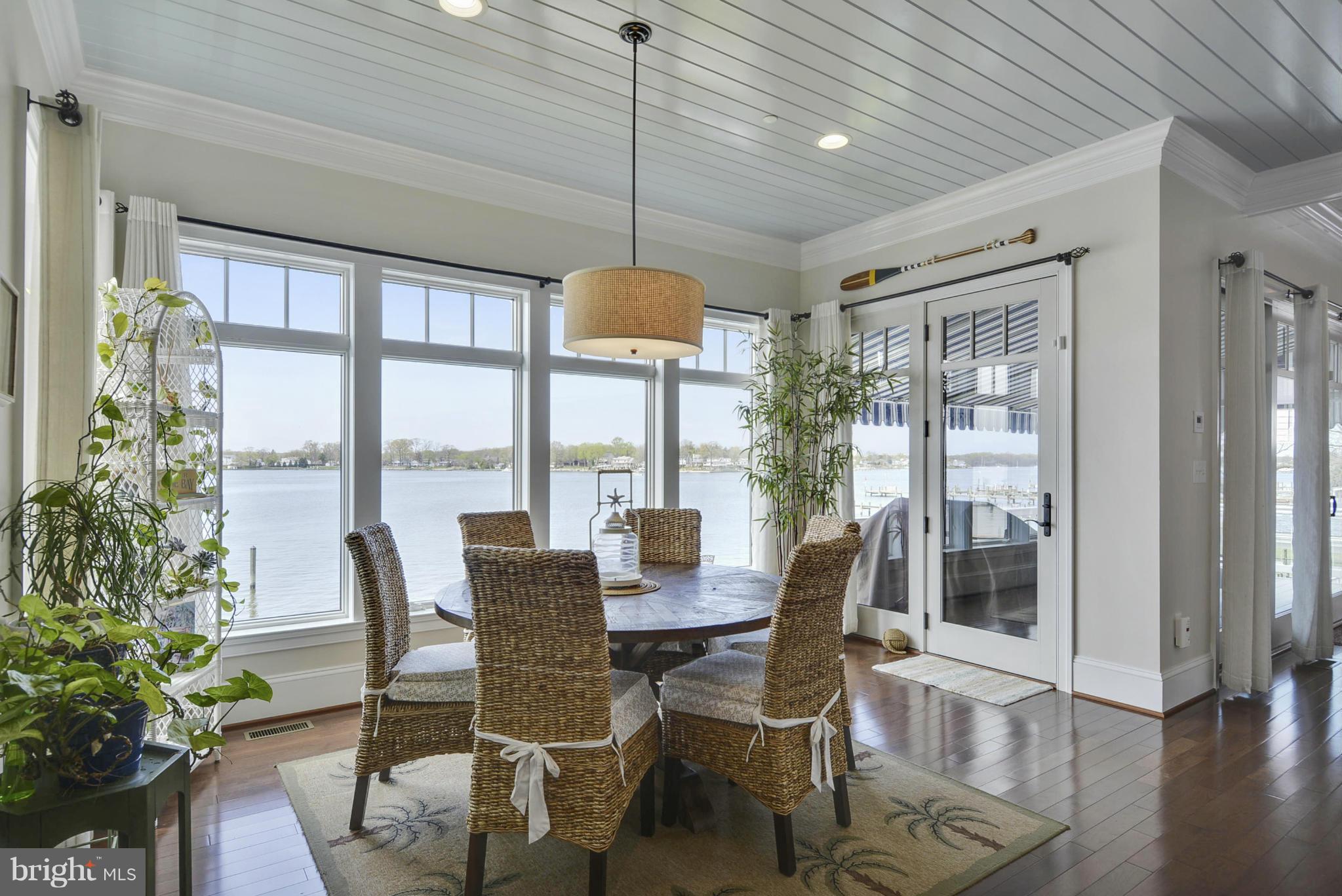 1824 Wilson Point Road Baltimore, MD 21220 - Photo 9 of 28 a dining room with furniture large windows and wooden floor