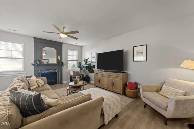 a kitchen with stainless steel appliances granite countertop a stove top oven a sink dishwasher a dining table and chairs with wooden floor