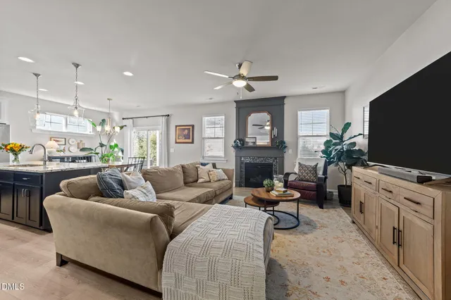 a kitchen with stainless steel appliances granite countertop a table chairs refrigerator and microwave