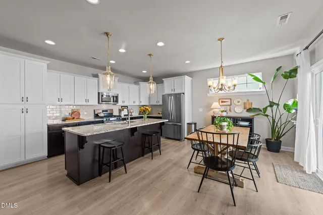 a kitchen with granite countertop a stove sink and cabinets