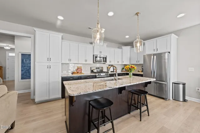 a kitchen with a stove sink and cabinets