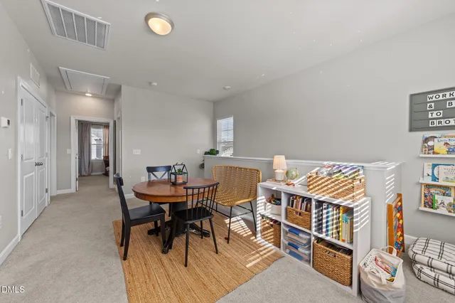 a spacious bedroom with a bed and a chandelier