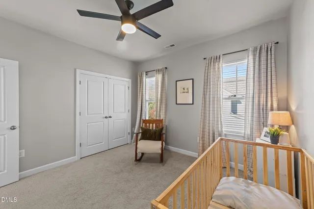 a bedroom with bed and a chandelier