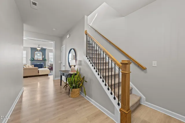 a view of a room with wooden floor and a table in it