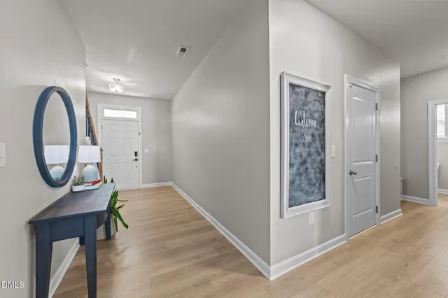 a bathroom with a toilet a sink a mirror a vanity and window