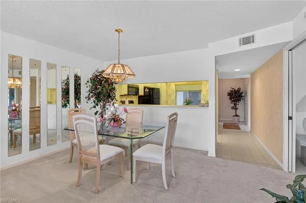 a view of a dining room with furniture and chandelier