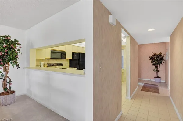 a view of a hallway with dining room and livingroom view