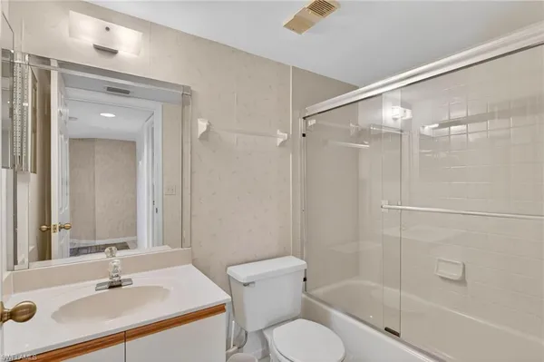 a bathroom with a sink toilet a shower and a mirror