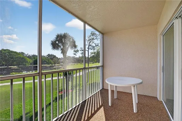a view of a balcony with furniture