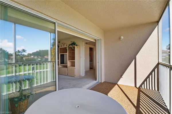 a bedroom with a bed and balcony