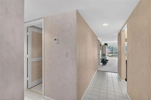 a view of a hallway with a wooden door