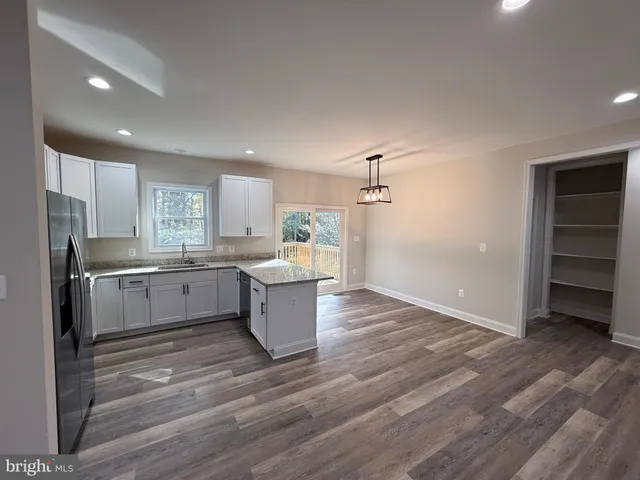 a large white kitchen with cabinets