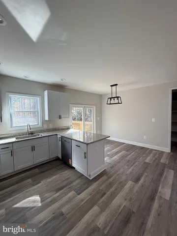a bathroom with a granite countertop toilet sink and shower
