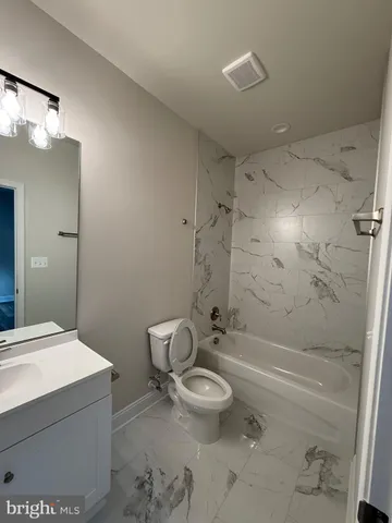 a view of a ocean with a house in the background