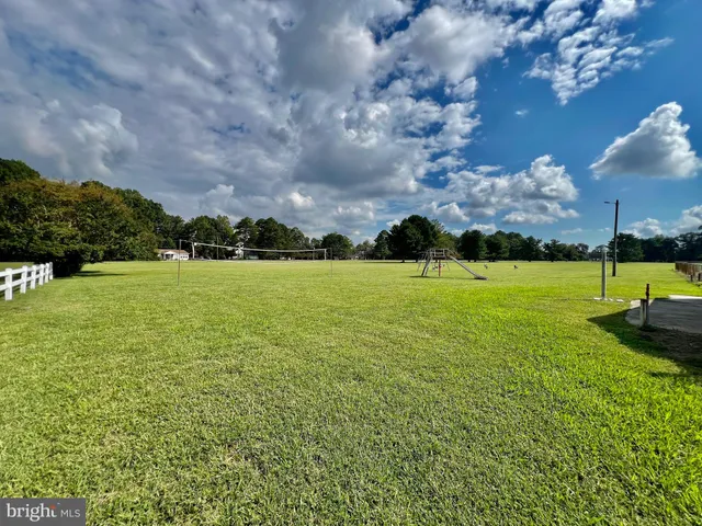 a view of a swimming pool with a yard