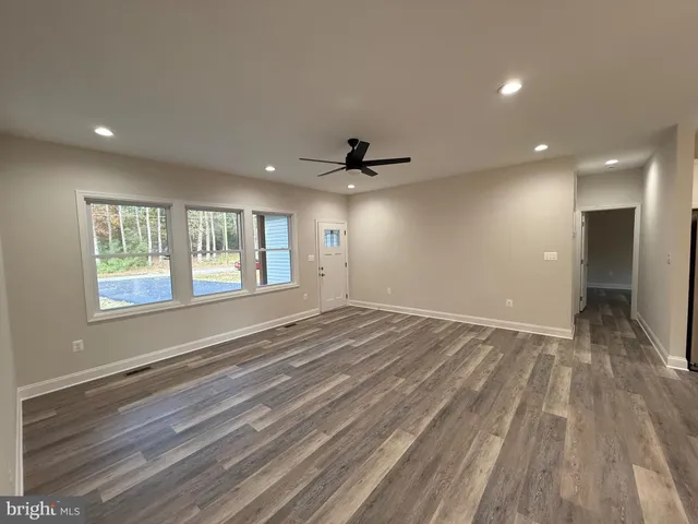 a view of an empty room with window and cabinet
