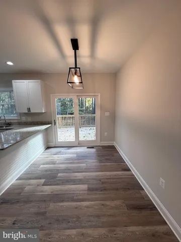 a kitchen with granite countertop white cabinets and stainless steel appliances
