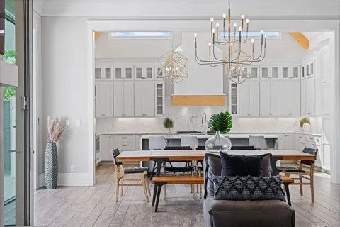 a kitchen with a table chairs and cabinets