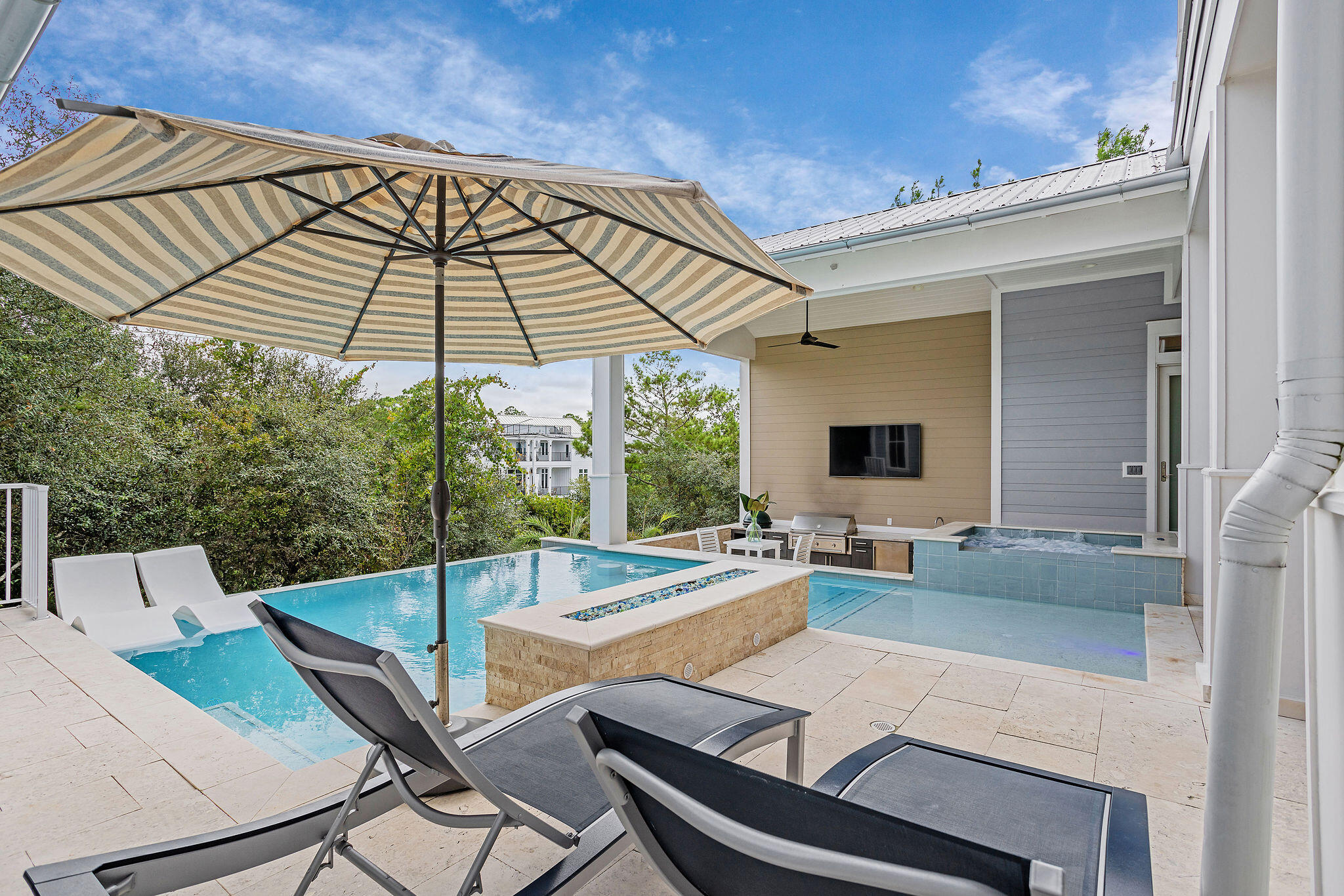 70 Bullard Road Santa Rosa Beach, FL 32459 - Photo 22 of 63 a view of a patio with couches table and chairs under an umbrella