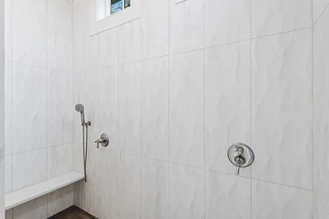 a bedroom with a large bed and a flat tv screen on dresser