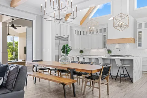 a kitchen with stainless steel appliances granite countertop a sink and white cabinets