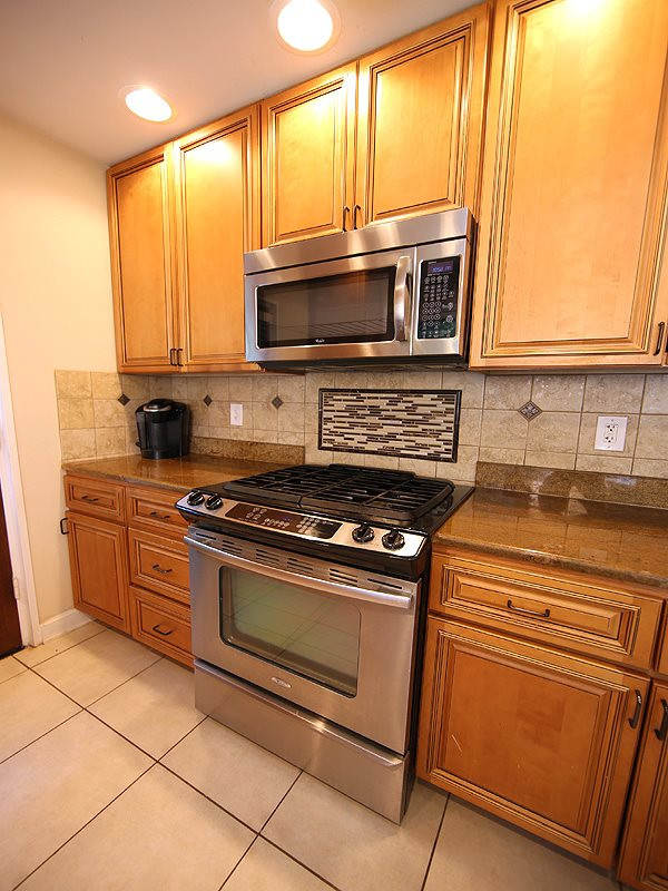 1315 Chaney Road Raleigh, NC 27606 - Photo 8 of 25 All the bells & whistles found here - soft close cabinetry, granite counter tops, stainless appliances tile backsplash, recessed can lighting. Kitchen