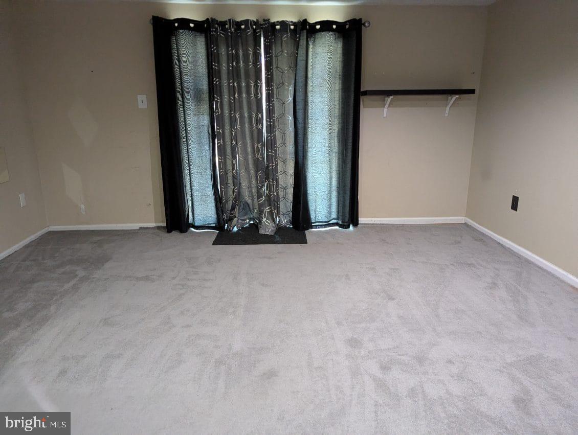 6945 Rockfield Road Baltimore, MD 21244 - Photo 2 of 10 a view of an empty room with wooden floor